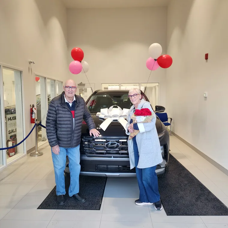 Customers celebrating new car purchase